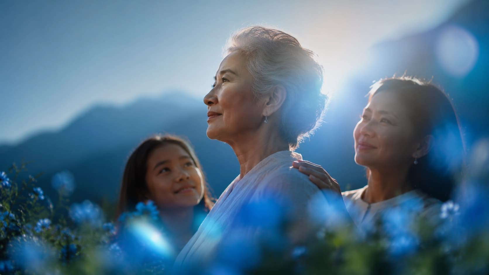 An older man outdoors with his family, warm and at ease together.