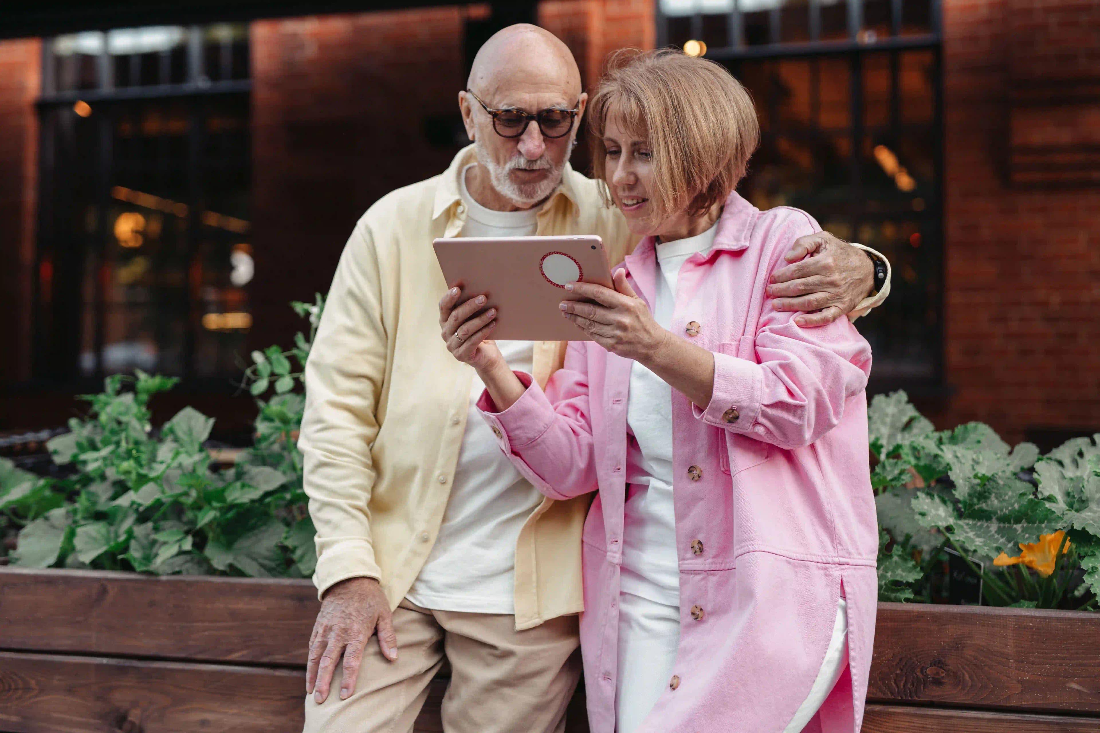 An older couple looking at a tablet together at home.